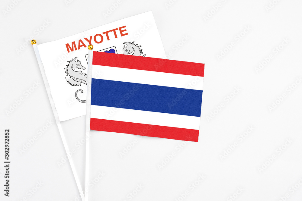 Thailand and Mayotte stick flags on white background. High quality fabric, miniature national flag. Peaceful global concept.White floor for copy space. Thailand and Mayotte stick flags on white background. High quality fabric, miniature national flag. Peaceful global concept.White floor for copy space.