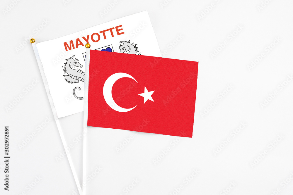 Turkey and Mayotte stick flags on white background. High quality fabric, miniature national flag. Peaceful global concept.White floor for copy space. Turkey and Mayotte stick flags on white background. High quality fabric, miniature national flag. Peaceful global concept.White floor for copy space.