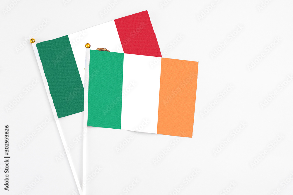 Ireland and Mexico stick flags on white background. High quality fabric, miniature national flag. Peaceful global concept.White floor for copy space. Ireland and Mexico stick flags on white background. High quality fabric, miniature national flag. Peaceful global concept.White floor for copy space.