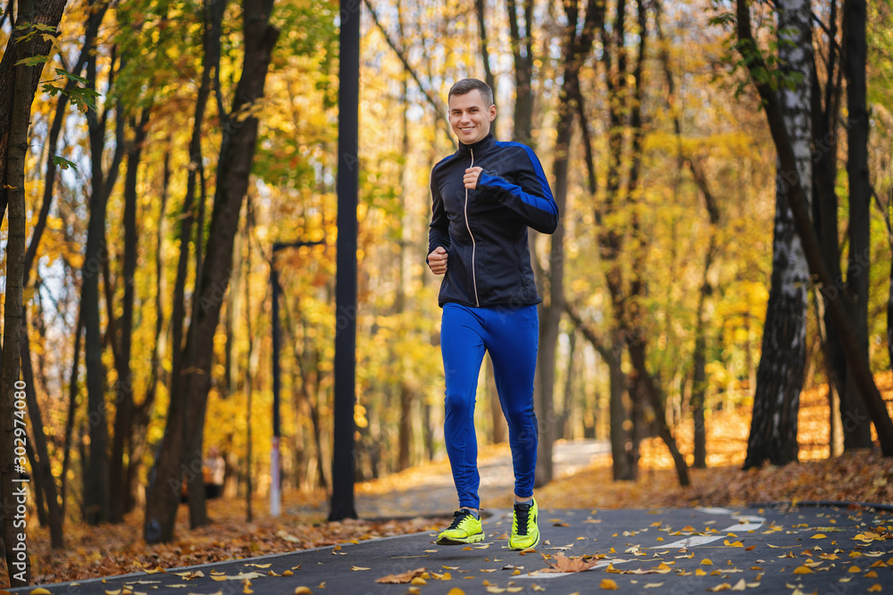 Athletic young man running in the nature. Healthy lifestyle Athletic young man running in the nature. Healthy lifestyle