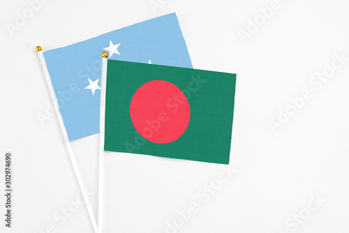 Bangladesh and Micronesia stick flags on white background. High quality fabric, miniature national flag. Peaceful global concept.White floor for copy space. Free Download Bangladesh and Micronesia stick flags on white background. High quality fabric, miniature national flag. Peaceful global concept.White floor for copy space. - GFXLoad