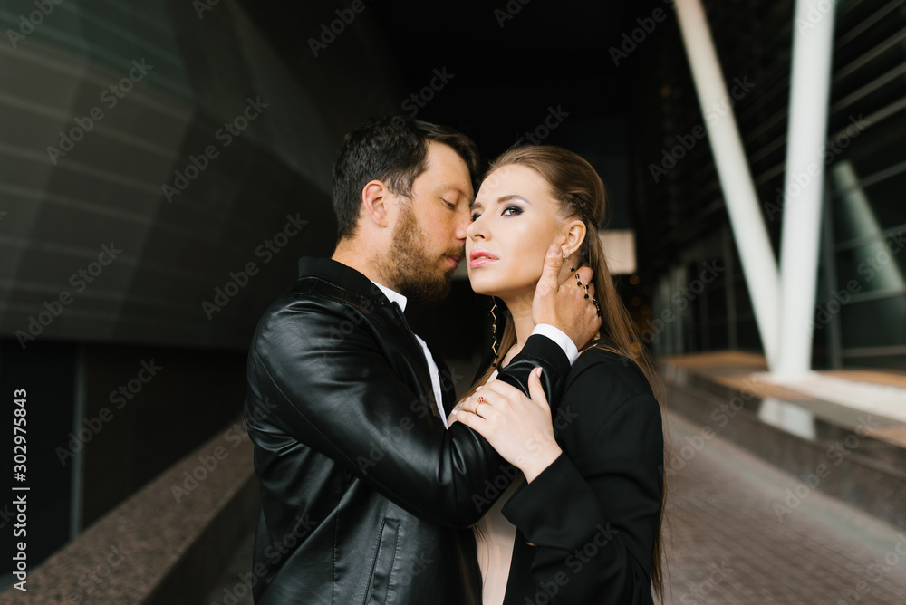 Loving dad in black clothes, kiss on the cheek. Business relationship. Office romance Loving dad in black clothes, kiss on the cheek. Business relationship. Office romance