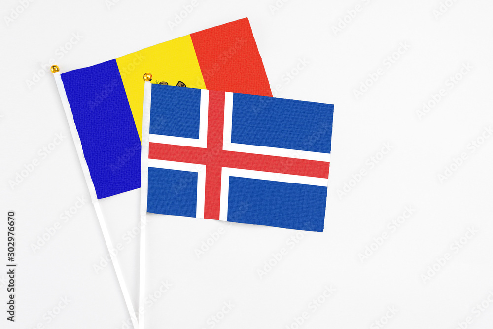 Iceland and Moldova stick flags on white background. High quality fabric, miniature national flag. Peaceful global concept.White floor for copy space.