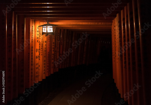 Tunnel of Tori Gates at night at Fushimi Inari Taisha in Kyoto, Japan.