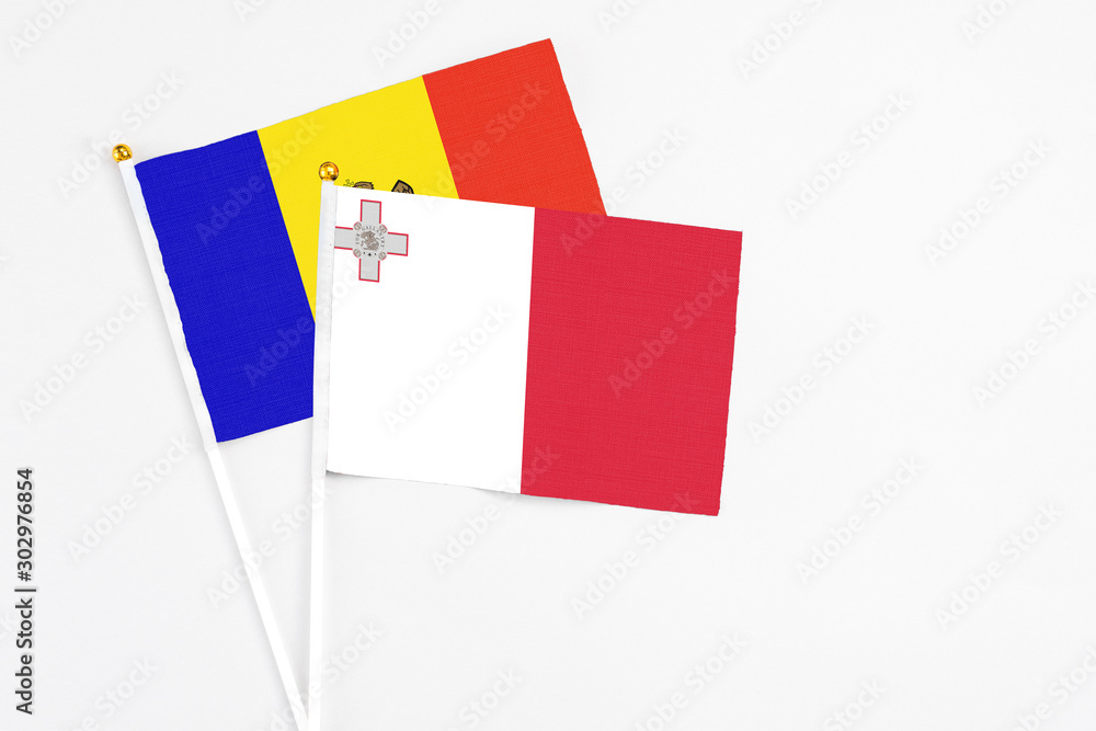 Malta and Moldova stick flags on white background. High quality fabric, miniature national flag. Peaceful global concept.White floor for copy space. Malta and Moldova stick flags on white background. High quality fabric, miniature national flag. Peaceful global concept.White floor for copy space.