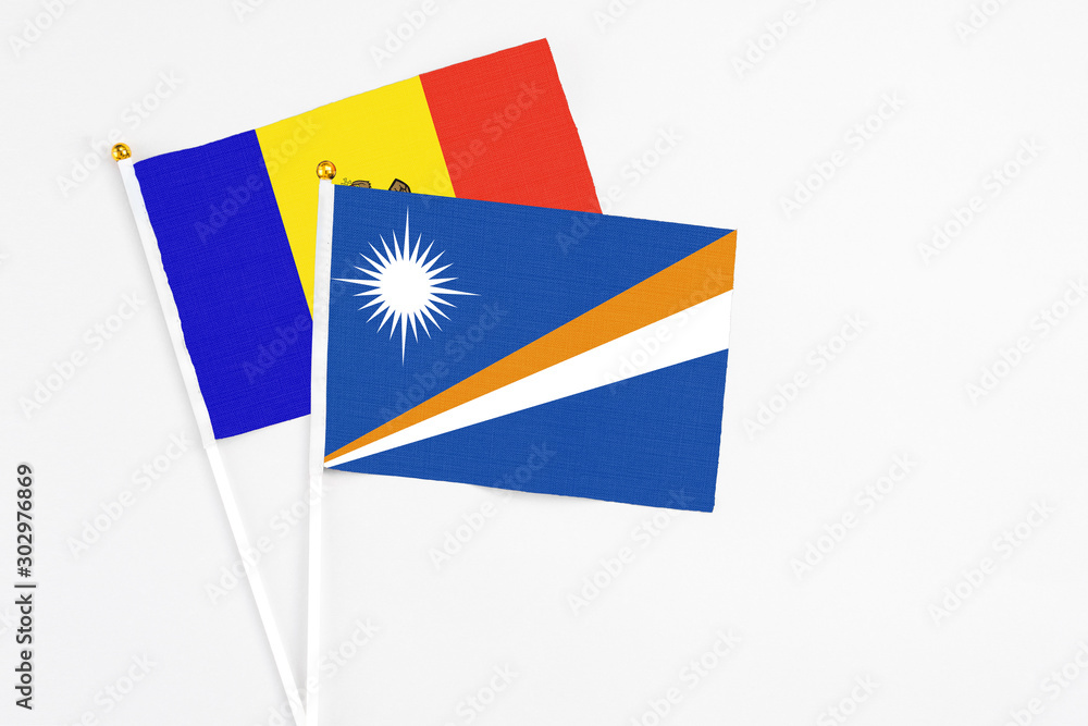 Marshall Islands and Moldova stick flags on white background. High quality fabric, miniature national flag. Peaceful global concept.White floor for copy space. Marshall Islands and Moldova stick flags on white background. High quality fabric, miniature national flag. Peaceful global concept.White floor for copy space.