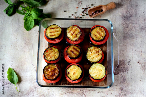 Grilled vegetables: tomatoes, eggplant on a glass dish