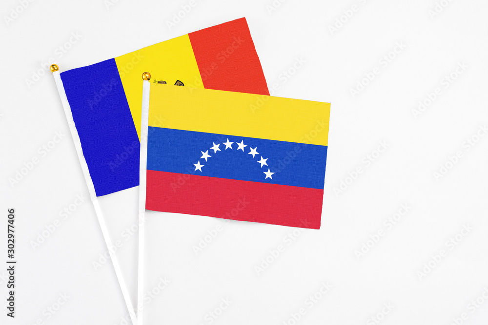 Venezuela and Moldova stick flags on white background. High quality fabric, miniature national flag. Peaceful global concept.White floor for copy space. Venezuela and Moldova stick flags on white background. High quality fabric, miniature national flag. Peaceful global concept.White floor for copy space.