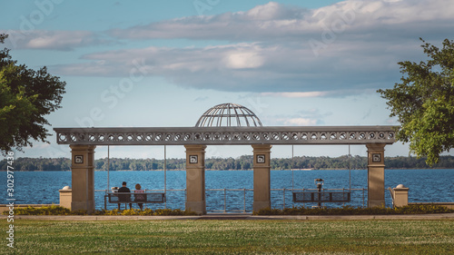 A couple sits on a swinging bench by Lake Monroe in downtown Sanford, Florida.