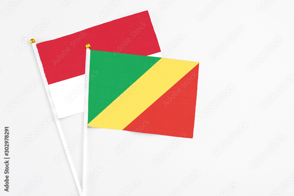 Republic Of The Congo and Monaco stick flags on white background. High quality fabric, miniature national flag. Peaceful global concept.White floor for copy space. Republic Of The Congo and Monaco stick flags on white background. High quality fabric, miniature national flag. Peaceful global concept.White floor for copy space.