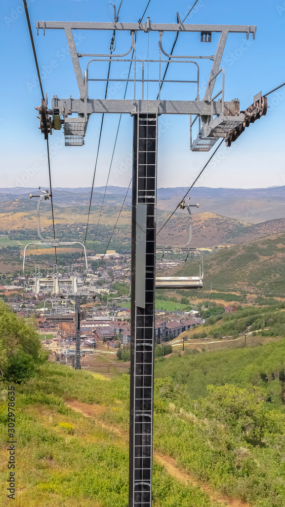 Vertical frame Hiking trails under chairlifts at ski resort mountain in Park City at off season