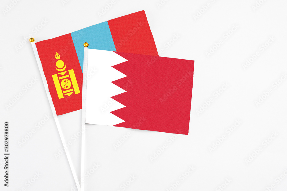 Bahrain and Mongolia stick flags on white background. High quality fabric, miniature national flag. Peaceful global concept.White floor for copy space. Bahrain and Mongolia stick flags on white background. High quality fabric, miniature national flag. Peaceful global concept.White floor for copy space.