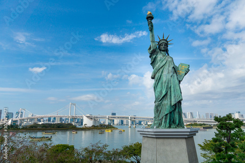 Statue of liberty and rainbow bridge in Tokyo, Japan photo