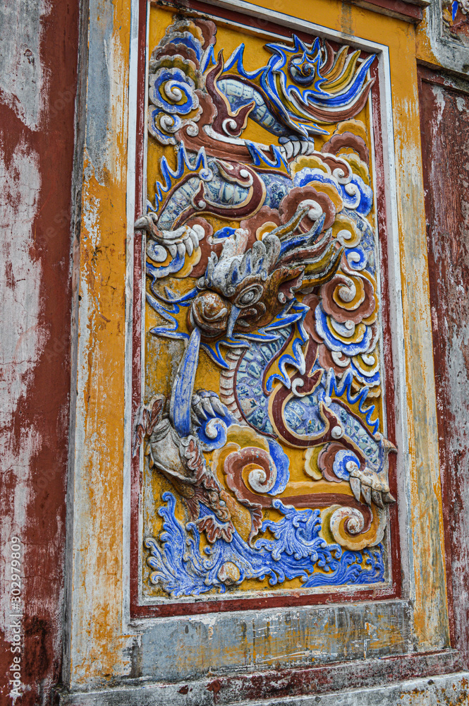 colorfull stone dragon carving on wall 