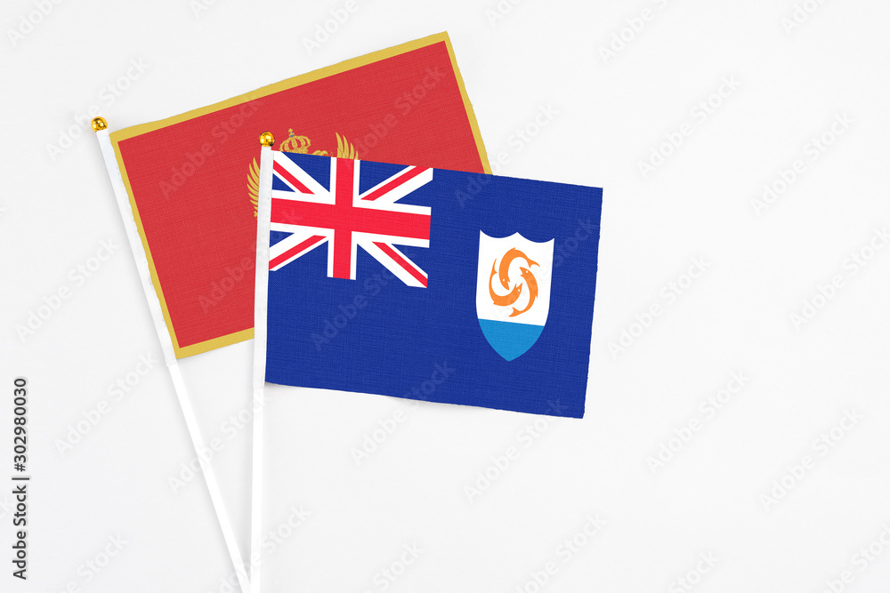 Fototapeta premium Anguilla and Montenegro stick flags on white background. High quality fabric, miniature national flag. Peaceful global concept.White floor for copy space.