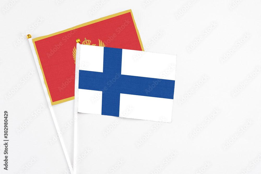 Finland and Montenegro stick flags on white background. High quality fabric, miniature national flag. Peaceful global concept.White floor for copy space. Finland and Montenegro stick flags on white background. High quality fabric, miniature national flag. Peaceful global concept.White floor for copy space.