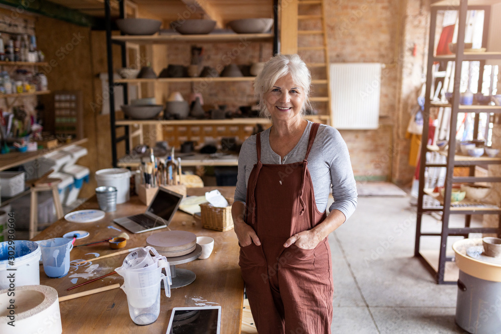 Portrait of senior female pottery artist in her art studio Portrait of senior female pottery artist in her art studio