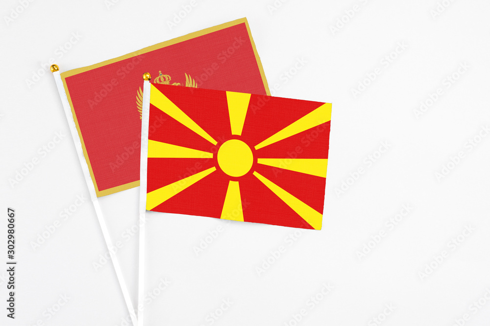 Macedonia and Montenegro stick flags on white background. High quality fabric, miniature national flag. Peaceful global concept.White floor for copy space.
