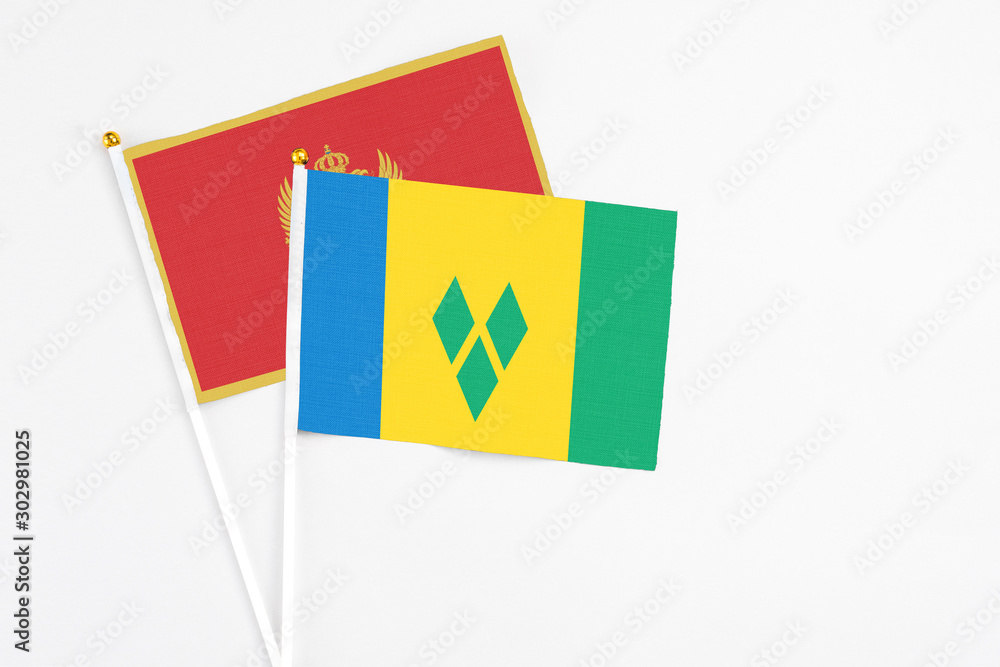 Saint Vincent And The Grenadines and Montenegro stick flags on white background. High quality fabric, miniature national flag. Peaceful global concept.White floor for copy space. Saint Vincent And The Grenadines and Montenegro stick flags on white background. High quality fabric, miniature national flag. Peaceful global concept.White floor for copy space.