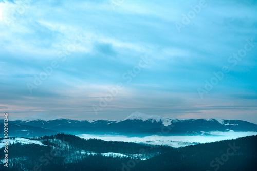 Winter Carpathian landscape in gray cloudy day.