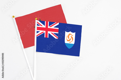 Anguilla and Morocco stick flags on white background. High quality fabric, miniature national flag. Peaceful global concept.White floor for copy space.