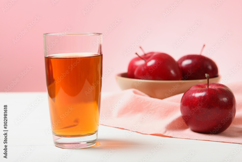apple juice from red apples on the table. apple juice from red apples on the table.