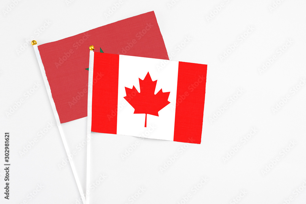 Canada and Morocco stick flags on white background. High quality fabric, miniature national flag. Peaceful global concept.White floor for copy space. Canada and Morocco stick flags on white background. High quality fabric, miniature national flag. Peaceful global concept.White floor for copy space.