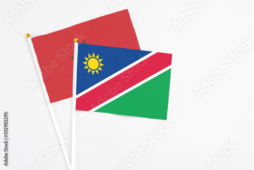 Free Download Namibia and Morocco stick flags on white background. High quality fabric, miniature national flag. Peaceful global concept.White floor for copy space. - GFXLoad