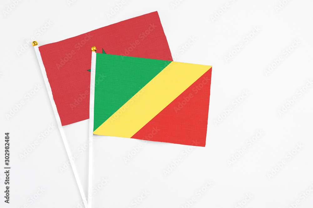 Republic Of The Congo and Morocco stick flags on white background. High quality fabric, miniature national flag. Peaceful global concept.White floor for copy space. Republic Of The Congo and Morocco stick flags on white background. High quality fabric, miniature national flag. Peaceful global concept.White floor for copy space.