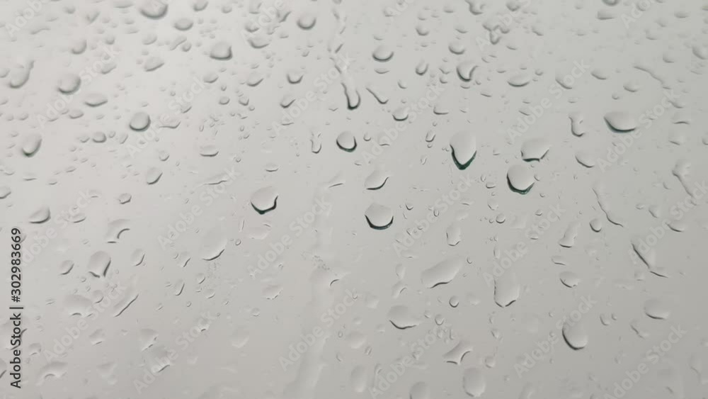 Close up view of water drops falling on glass. Close up view of water drops falling on glass.