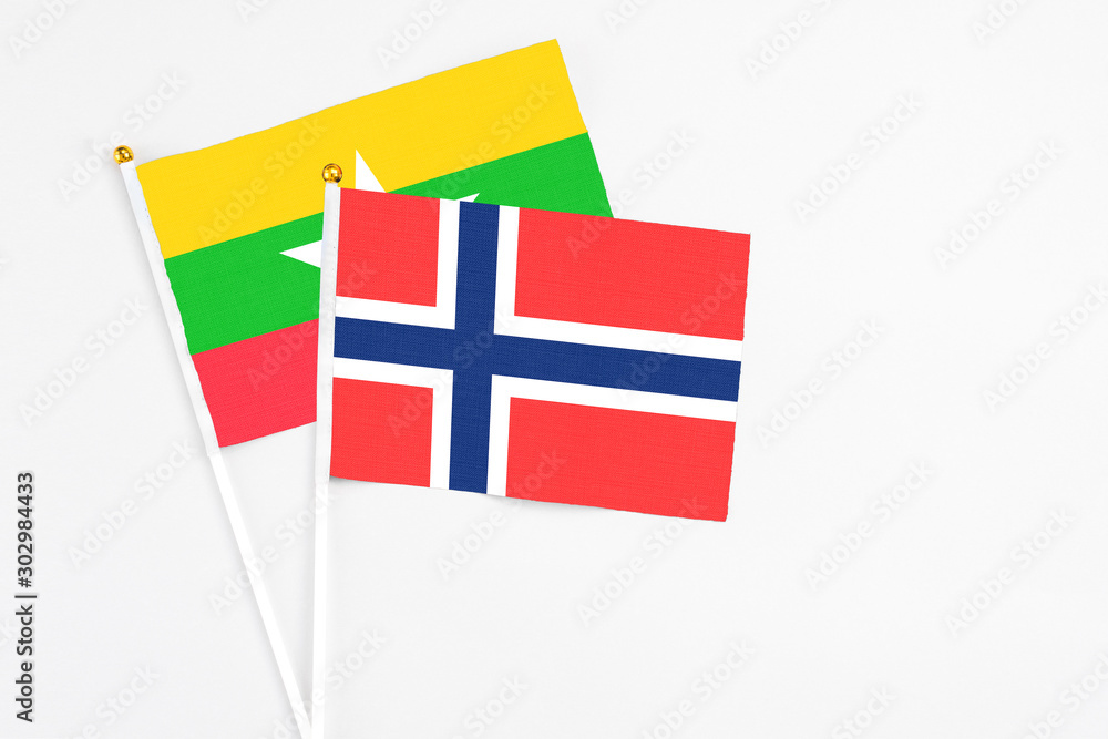 Bouvet Islands and Myanmar stick flags on white background. High quality fabric, miniature national flag. Peaceful global concept.White floor for copy space.