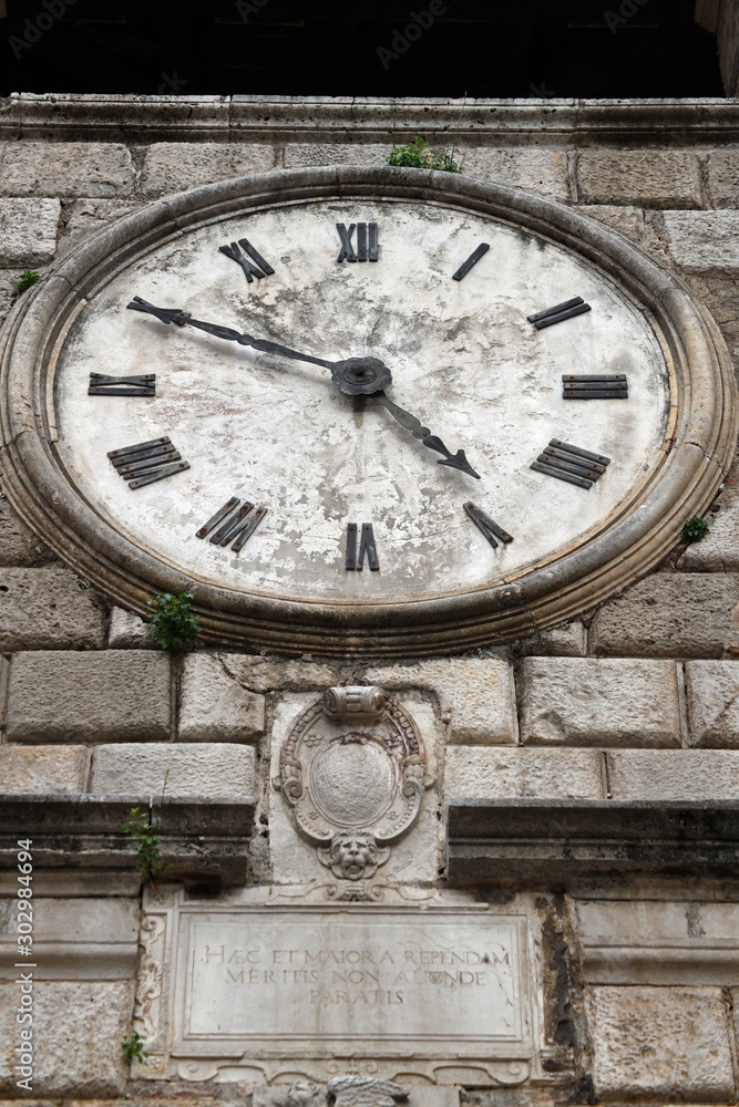 A beautiful old clock on a stone tower. Clock tower, a symbol of the old town of Kotor. A beautiful old clock on a stone tower. Clock tower, a symbol of the old town of Kotor.
