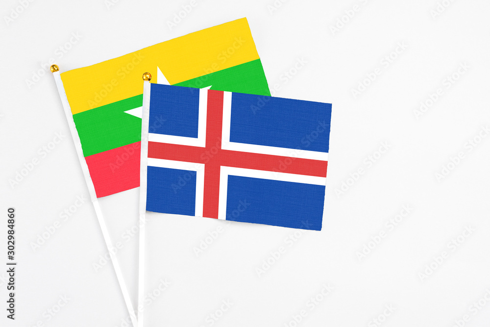 Iceland and Myanmar stick flags on white background. High quality fabric, miniature national flag. Peaceful global concept.White floor for copy space.