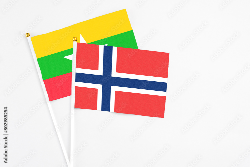 Norway and Myanmar stick flags on white background. High quality fabric, miniature national flag. Peaceful global concept.White floor for copy space. Norway and Myanmar stick flags on white background. High quality fabric, miniature national flag. Peaceful global concept.White floor for copy space.