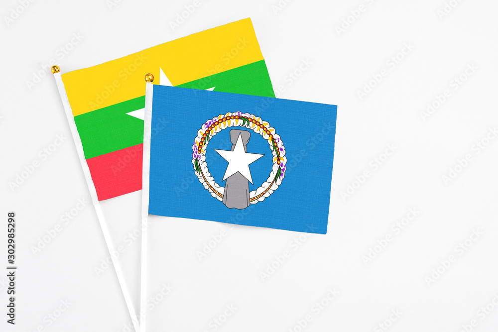 Northern Mariana Islands and Myanmar stick flags on white background. High quality fabric, miniature national flag. Peaceful global concept.White floor for copy space. Northern Mariana Islands and Myanmar stick flags on white background. High quality fabric, miniature national flag. Peaceful global concept.White floor for copy space.