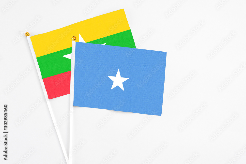 Somalia and Myanmar stick flags on white background. High quality fabric, miniature national flag. Peaceful global concept.White floor for copy space. Somalia and Myanmar stick flags on white background. High quality fabric, miniature national flag. Peaceful global concept.White floor for copy space.