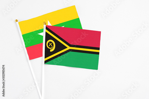 Vanuatu and Myanmar stick flags on white background. High quality fabric  miniature national flag. Peaceful global concept.White floor for copy space.