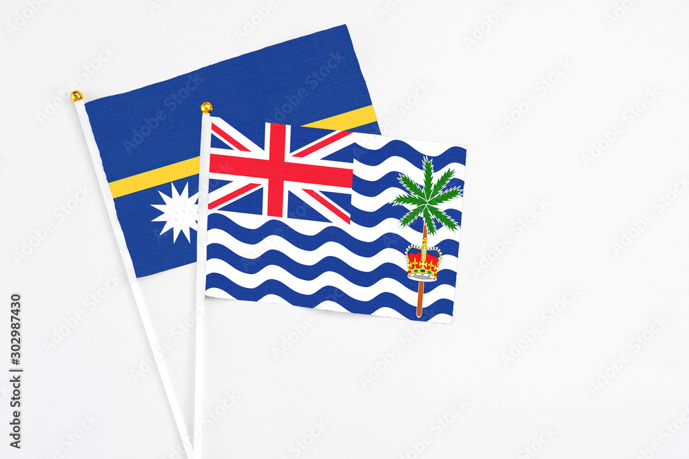Fototapeta premium British Indian Ocean Territory and Nauru stick flags on white background. High quality fabric, miniature national flag. Peaceful global concept.White floor for copy space.