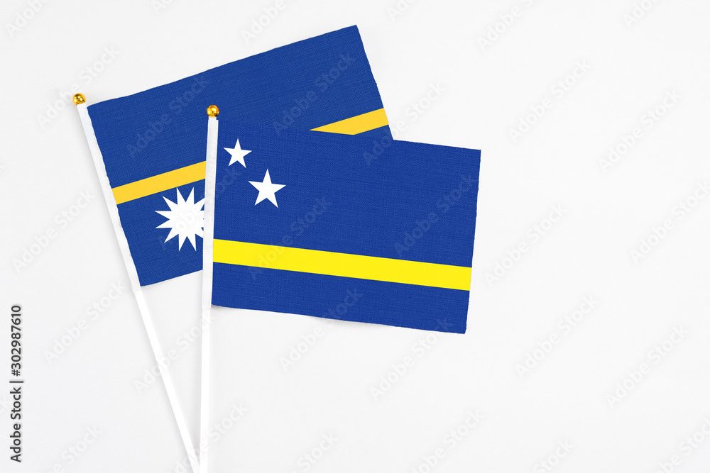 Curacao and Nauru stick flags on white background. High quality fabric, miniature national flag. Peaceful global concept.White floor for copy space. Curacao and Nauru stick flags on white background. High quality fabric, miniature national flag. Peaceful global concept.White floor for copy space.