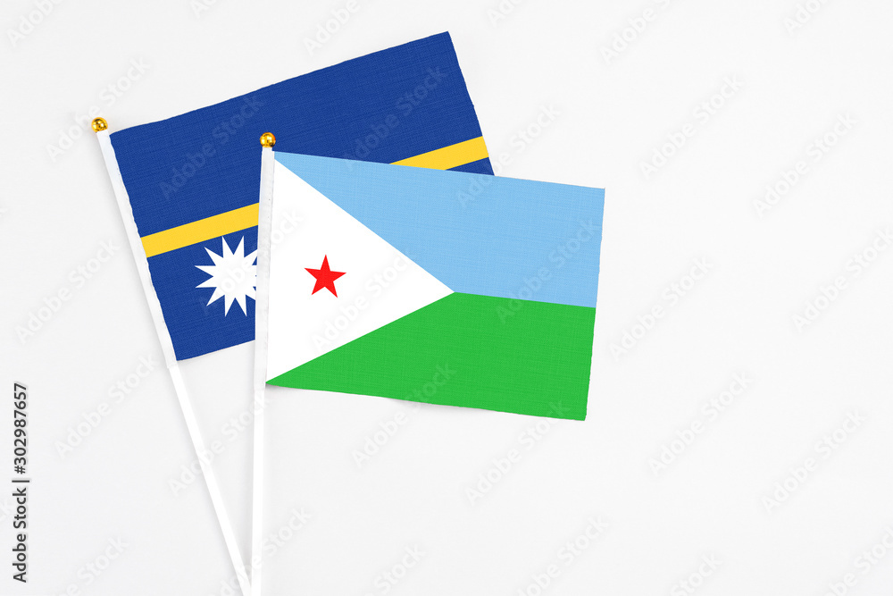 Djibouti and Nauru stick flags on white background. High quality fabric, miniature national flag. Peaceful global concept.White floor for copy space. Djibouti and Nauru stick flags on white background. High quality fabric, miniature national flag. Peaceful global concept.White floor for copy space.