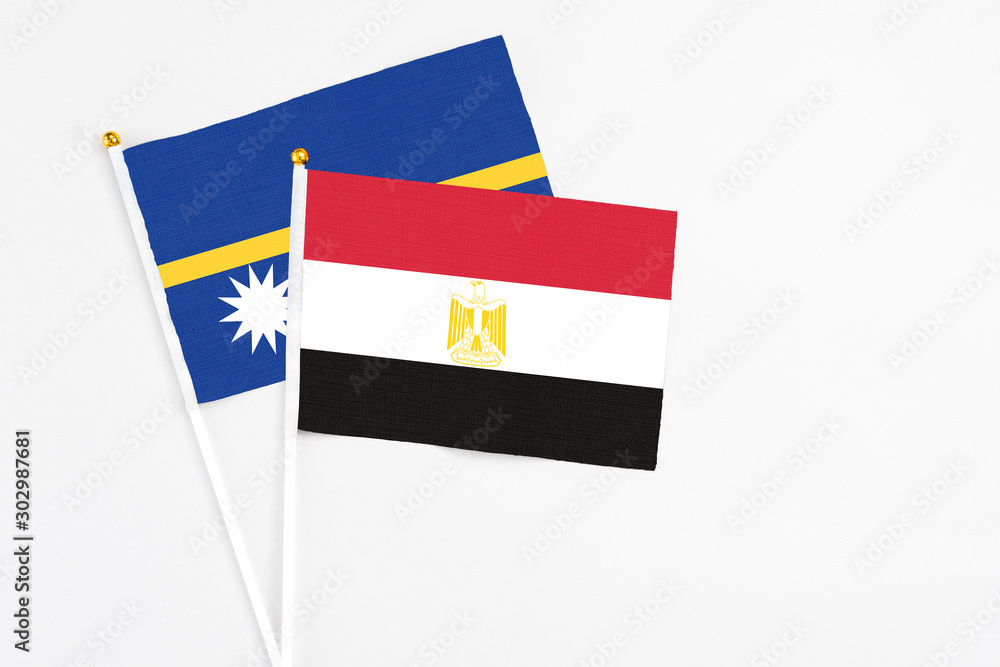 Egypt and Nauru stick flags on white background. High quality fabric, miniature national flag. Peaceful global concept.White floor for copy space. Egypt and Nauru stick flags on white background. High quality fabric, miniature national flag. Peaceful global concept.White floor for copy space.