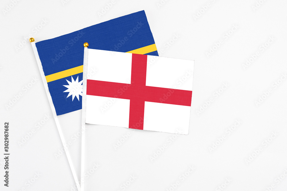 England and Nauru stick flags on white background. High quality fabric, miniature national flag. Peaceful global concept.White floor for copy space.