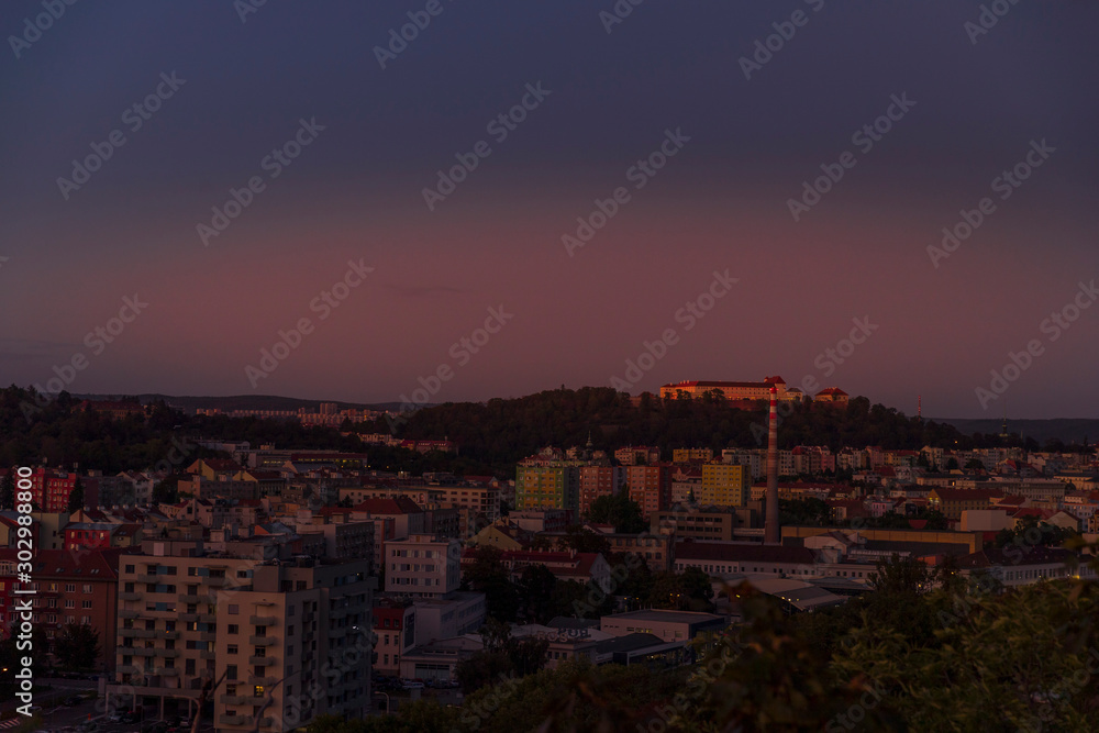 Castle Spilberk time-lapse captured in wide before sunset and castle turn on red light view in Brno city streets with building and surround area.