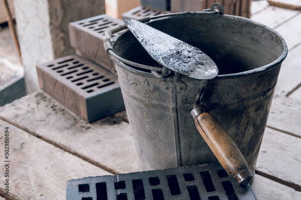 Workplace for a bricklayer close-up. Trowel for bricklaying. Workplace for a bricklayer close-up. Trowel for bricklaying.