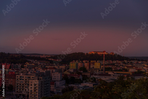 Castle Spilberk time-lapse captured in wide before sunset and castle turn on red light view in Brno city streets with building and surround area.