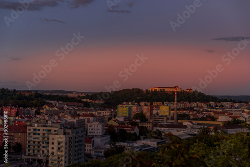 Castle Spilberk time-lapse captured in wide before sunset and castle turn on red light view in Brno city streets with building and surround area.