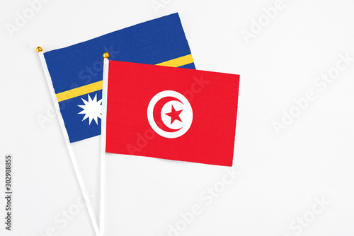 Free Download Tunisia and Nauru stick flags on white background. High quality fabric, miniature national flag. Peaceful global concept.White floor for copy space. - GFXLoad