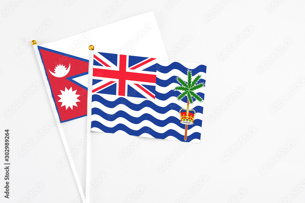 Fototapeta premium British Indian Ocean Territory and Nepal stick flags on white background. High quality fabric, miniature national flag. Peaceful global concept.White floor for copy space.