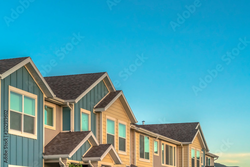 Exterior of upper storey of townhomes with blue sky background on a sunny day photo