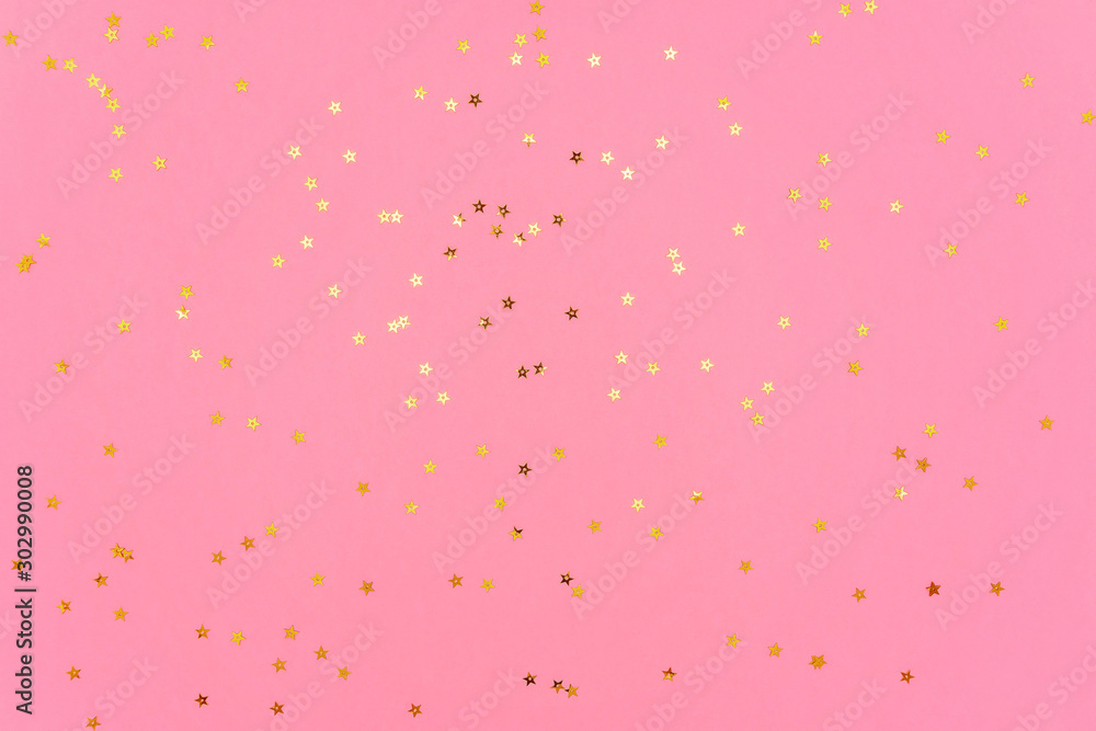 Photo of gold color stars glitter sprinkles on pink trendy background. Festive holiday background for your projects. Celebration concept. Christmas pattern. Top view, flat lay Photo of gold color stars glitter sprinkles on pink trendy background. Festive holiday background for your projects. Celebration concept. Christmas pattern. Top view, flat lay